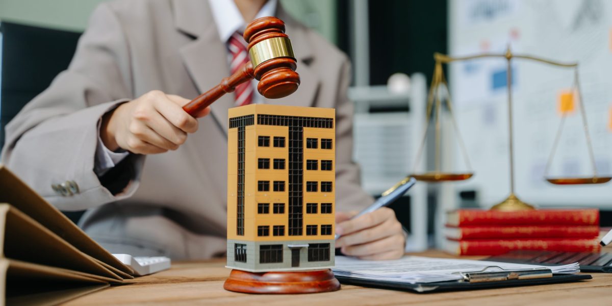 Real Estate Lawyer And House Foreclosure Law. House model, hammer judge gavel on table with white background. Foreclosure, bankruptcy concept Person is unable